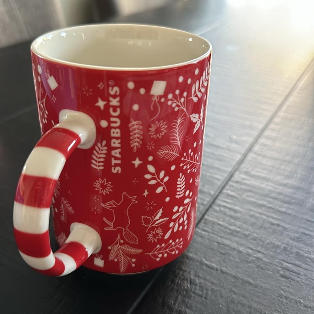 Like new Starbucks holiday ceramic mug, red with striped handle